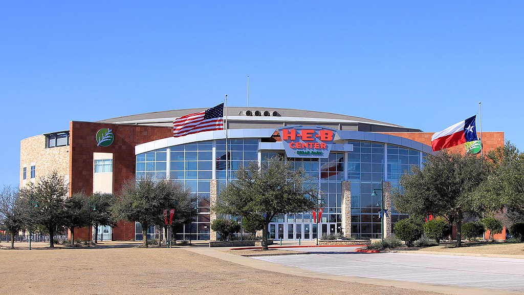 HEB Center exterior with American and Texas flags.