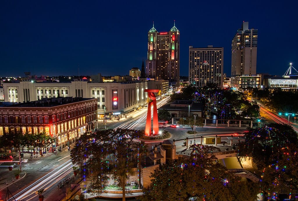 Downtown San Antonio skyline at night with lights.