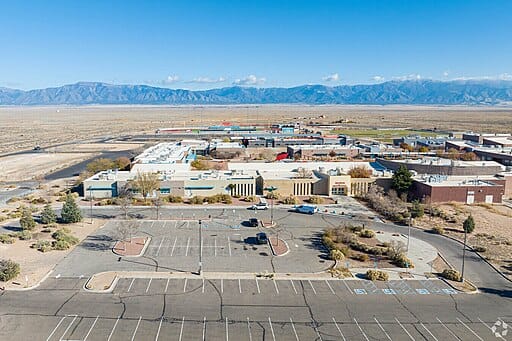 Aerial view of industrial buildings and desert landscape.
