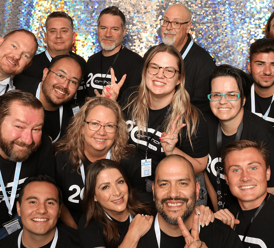 Smiling group celebrating 20th anniversary