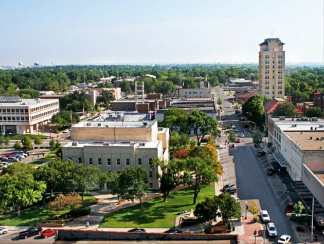 Aerial view of a cityscape with greenery.